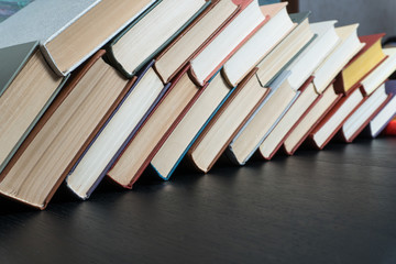 Book stacking open book hardback books on wooden table. copy space