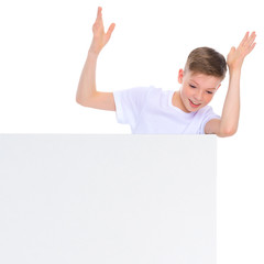 A boy of school age near a white advertising banner.