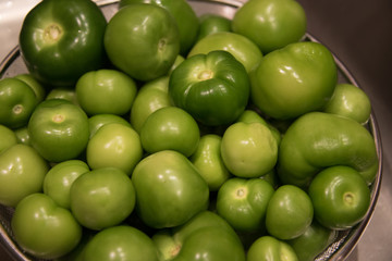 Green tomatillo dripping dry on strainer