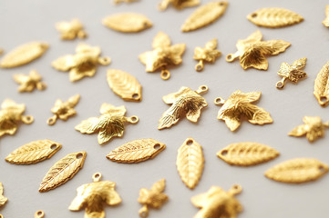 Plenty of gold shining metal leaves. Jewelry findings