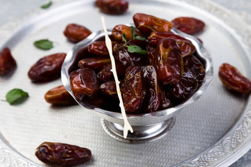 Dry fruit dates on silver tray. Copy space.