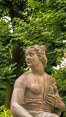 Fototapeta na wymiar Susannabrunnen (Susanna fountain) - statue of young half naked woman startled by someones presence while bathing. Created by Hans Waldburger, 1700. Mirabellgarten (Mirabell garden), Salzburg, Austria