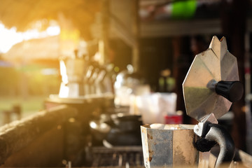 Close up coffee pot old aluminum open breakfast morning market on stove with sunlight