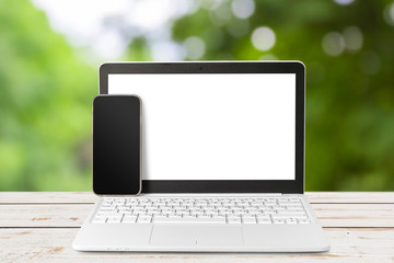 Laptop with blank screen on table