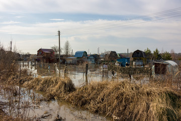 Fototapeta na wymiar Flooded summer cottages and houses during the spring high water, April 