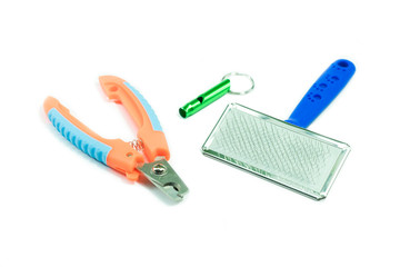 Pet Accessories concept.  Brush, nail scissors and Whistle on isolated white background.
