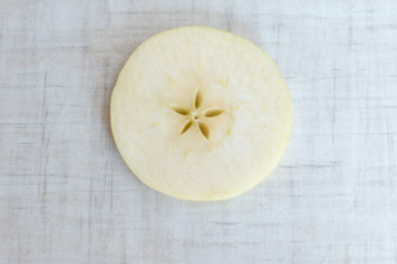 Apple cut into slices, background top view
