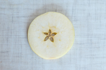Apple cut into slices, background top view