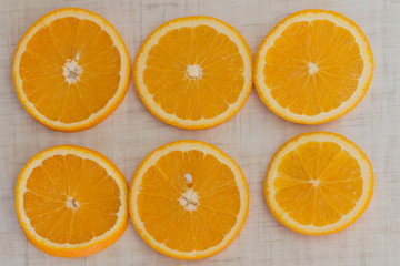 Orange cut into slices, background top view