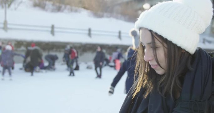 Young woman on rideau canal during winter festival - side profile