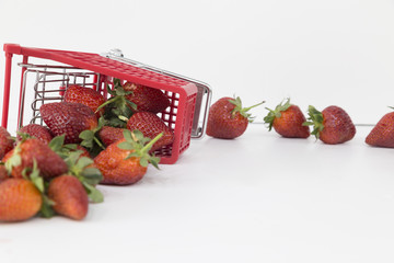 Strawberries in Shopping Cart, Isolated on White Background. Buying a strawberries from supermarket.