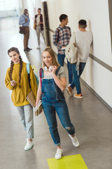 group of high school students spending time at school corridor during break