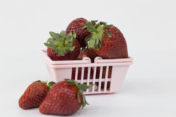 Strawberries in Shopping Cart, Isolated on White Background. Buying a strawberries from supermarket.