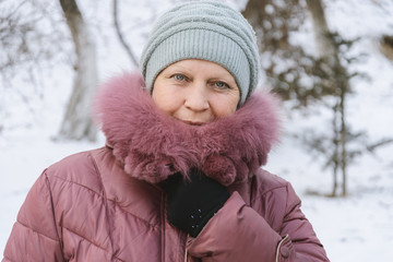 Portrait of a beautiful middle-aged woman outdoors. Selective focus. Color toned.