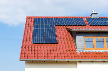 solar panels or photovoltaic plant on a red roof with tiles