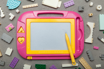 Games with children's educational toys. Magnetic board for drawing and constructor.