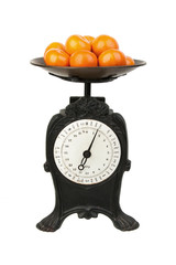 Old-fashioned kitchen scale on white