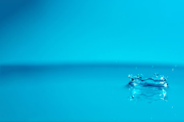 Naklejka na ściany i meble close-up water drop with blue background wallpaper