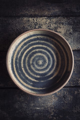 Empty ceramic plate on the wooden background