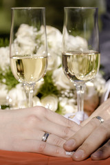 Two golden wedding rings on silk and glasses.