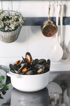 Pot with mussels on kitchen