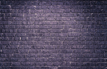 Grunge violet concrete wall with imitation brickwork as background.