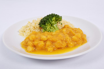 Roman peas with pumpkin and bulgur on a white