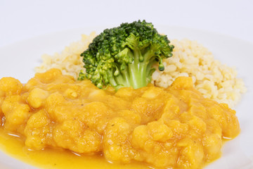 Roman peas with pumpkin and bulgur on a white