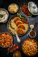 Assorted jewish and arabic levante cuisine prepared food in dishes and pans