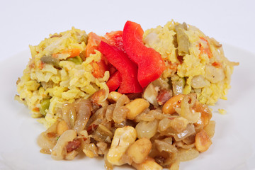 Risotto with vegetables and nuts on a white