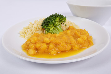 Roman peas with pumpkin and bulgur on a white