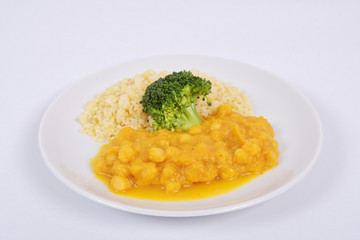 Roman peas with pumpkin and bulgur on a white
