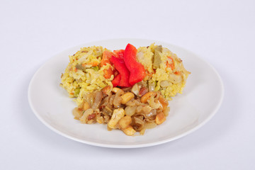 Risotto with vegetables and nuts on a white