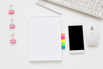 white Desk, smart phone, lying on the table, white background with copy space, for advertisement, top view