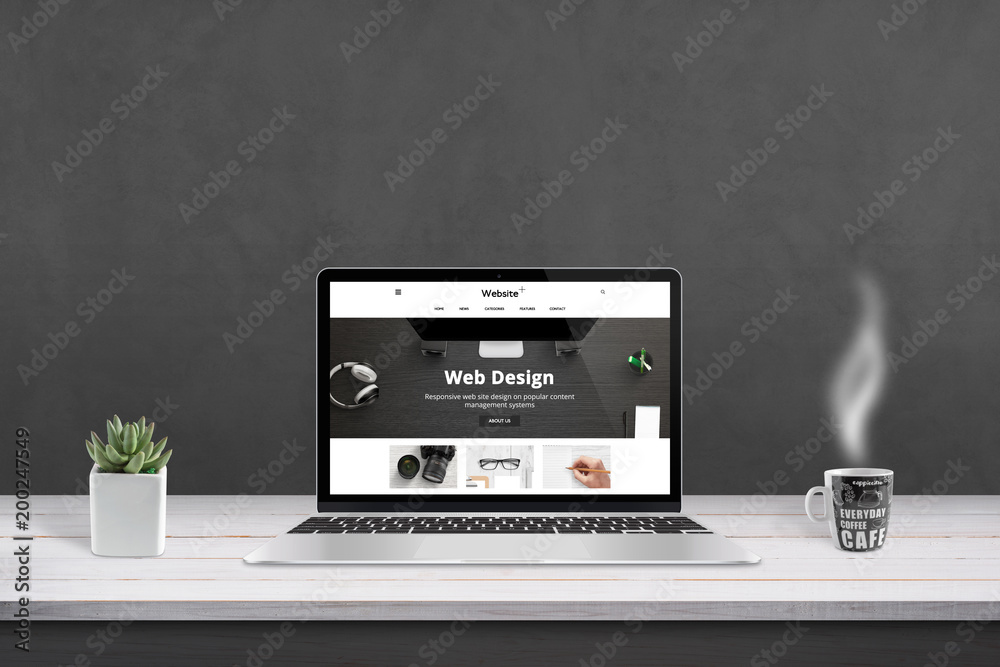 Aufkleber web design agency presentation with responsive, flat web site design on laptop display. cup of coffe