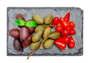 Mixed Pickles on stone serving board. Olives, Capers and peppers