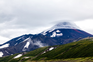 Lenticular (lens-shaped) clouds are over Avachinsky Volcano. Kamchatka Peninsula, Russia.