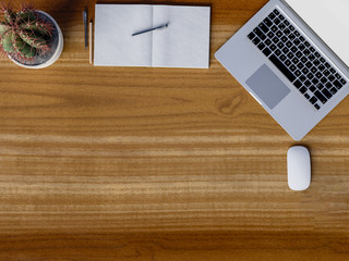 Top view of workspace on wooden table.