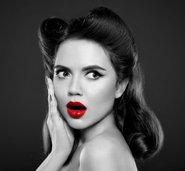 Pin up girl with red lips. Wow face expressions emotion. Retro vintage Woman surprise holds cheeks by hand isolated on black background.