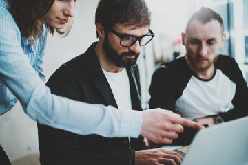 Concept of teamwork process at office.Young team working together at modern office loft.Blurred background.Horizontal.