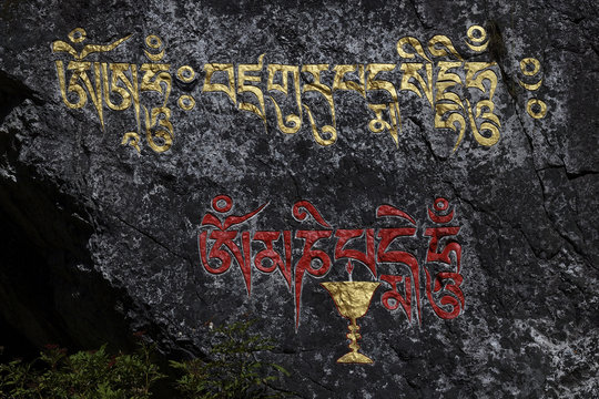 Tibetan writing on a rock