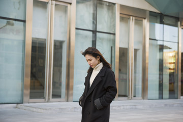 Fototapeta premium Young woman walking on street. Street photography. Fashion Shoot in the Streets 