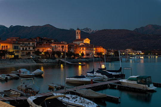 Reflections on the water by the lake at sunset. Feriolo, Lake Maggiore, Italy.
