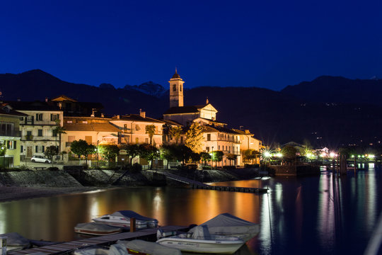 Reflections on the water by the lake at sunset. Feriolo, Lake Maggiore, Italy.