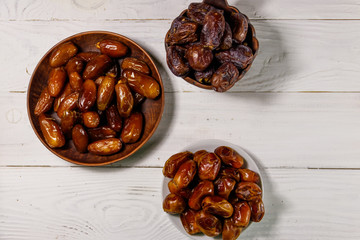 Dried dates fruit on white wooden table. Top view
