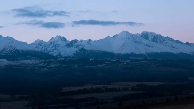 Time lapse footage of majestic High Tatras in Slovakia, Europe. Footage of mountains with last rays of setting sun during a blue hour.