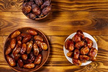 Dried dates fruit on wooden table. Top view