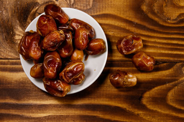 Dried dates fruit on wooden table. Top view