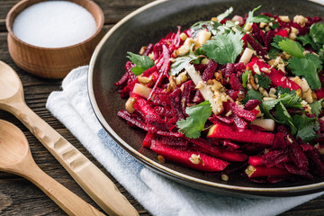 beet salad on a wooden table, apple, coriander, walnut, Jewish cuisine, Jewish New Year, Rosh Hashanah,