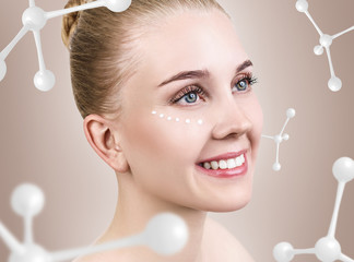 Young woman with cream dots among white molecules.